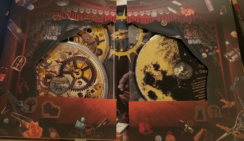 box that has the discs opened. you can see 3 discs behind some curtains