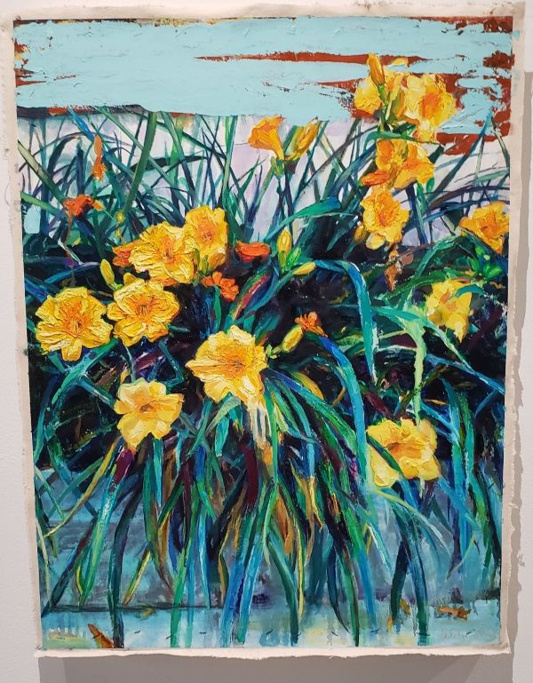 picture of a painting of oil on canvas. it pictures a blue background with yellow flowers.