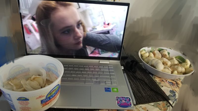 laptop with paranormal activity 4 playing with bowls of peeled garlic on its side